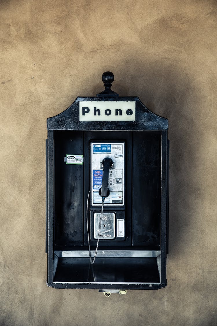 Vintage Public Telephone On Concrete Wall