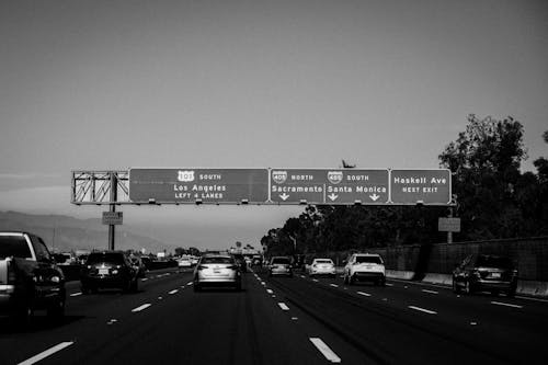 Grayscale Photo of Cars on Expressway Road