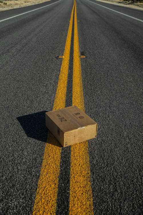Free Box on Yellow Lines on the Road Stock Photo