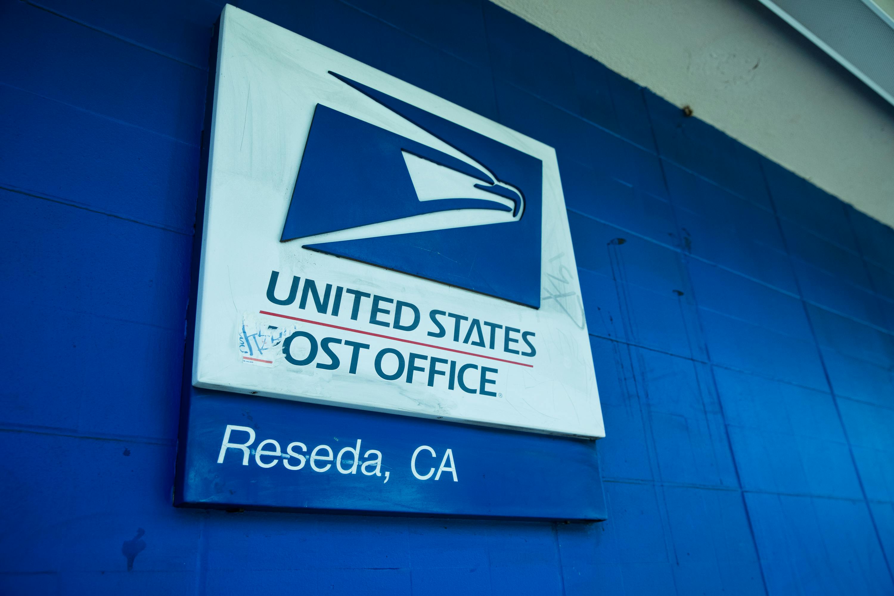 post office signage on concrete wall