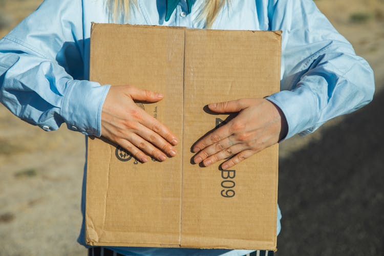 Person Holding A Carton Box