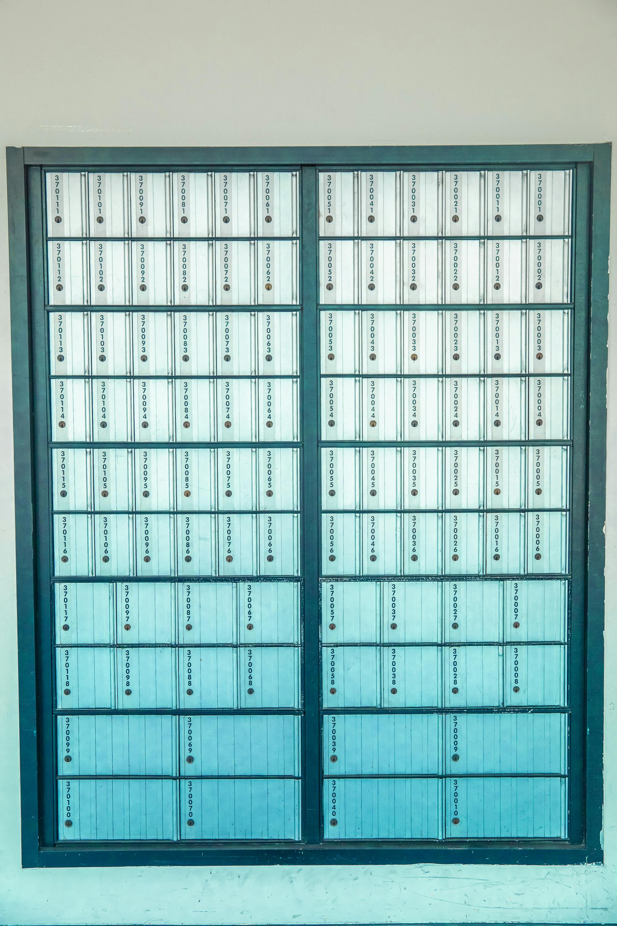 Vertical arrangement of metal mailboxes with a repetitive pattern in Los Angeles, CA.
