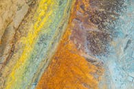 特写镜头展示了彩色纹理岩石表面，呈现自然图案与充满活力的色调