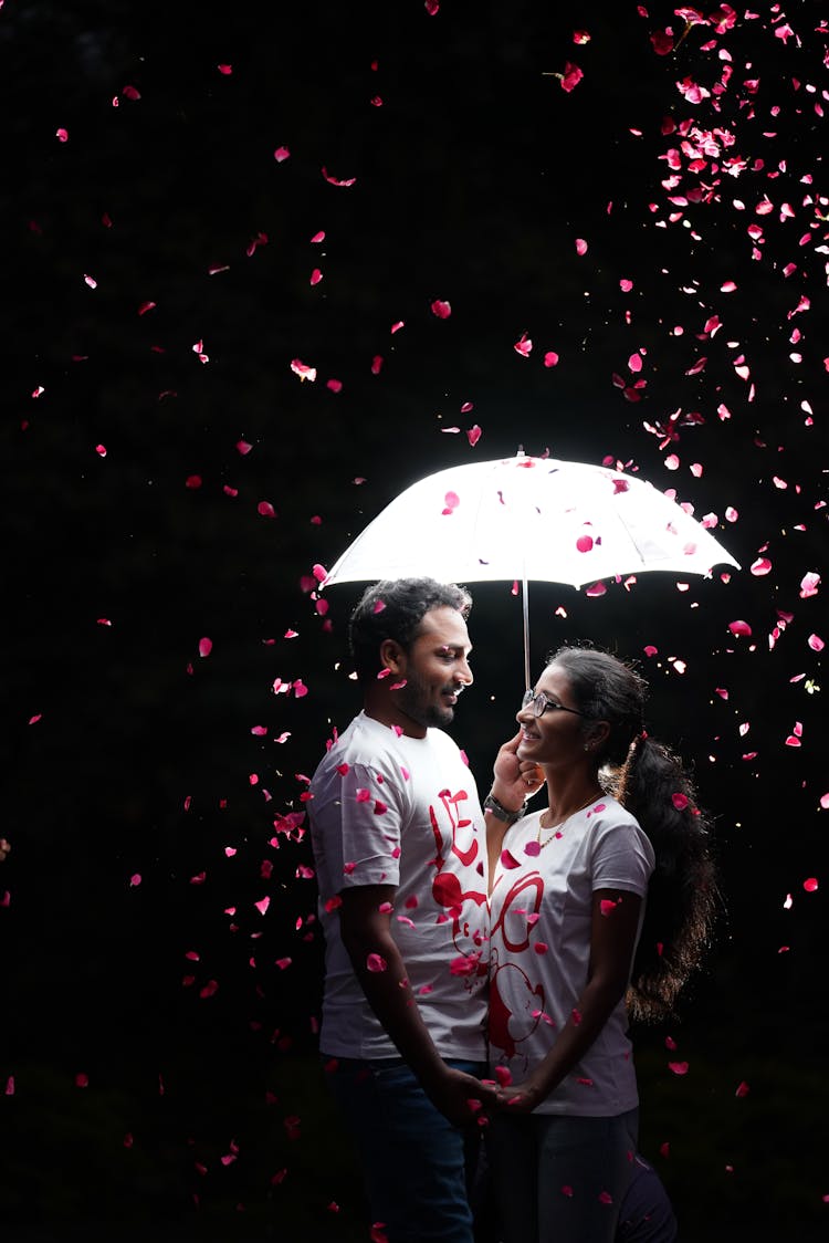 Man In White Shirt Holding Umbrella While Facing A Woman