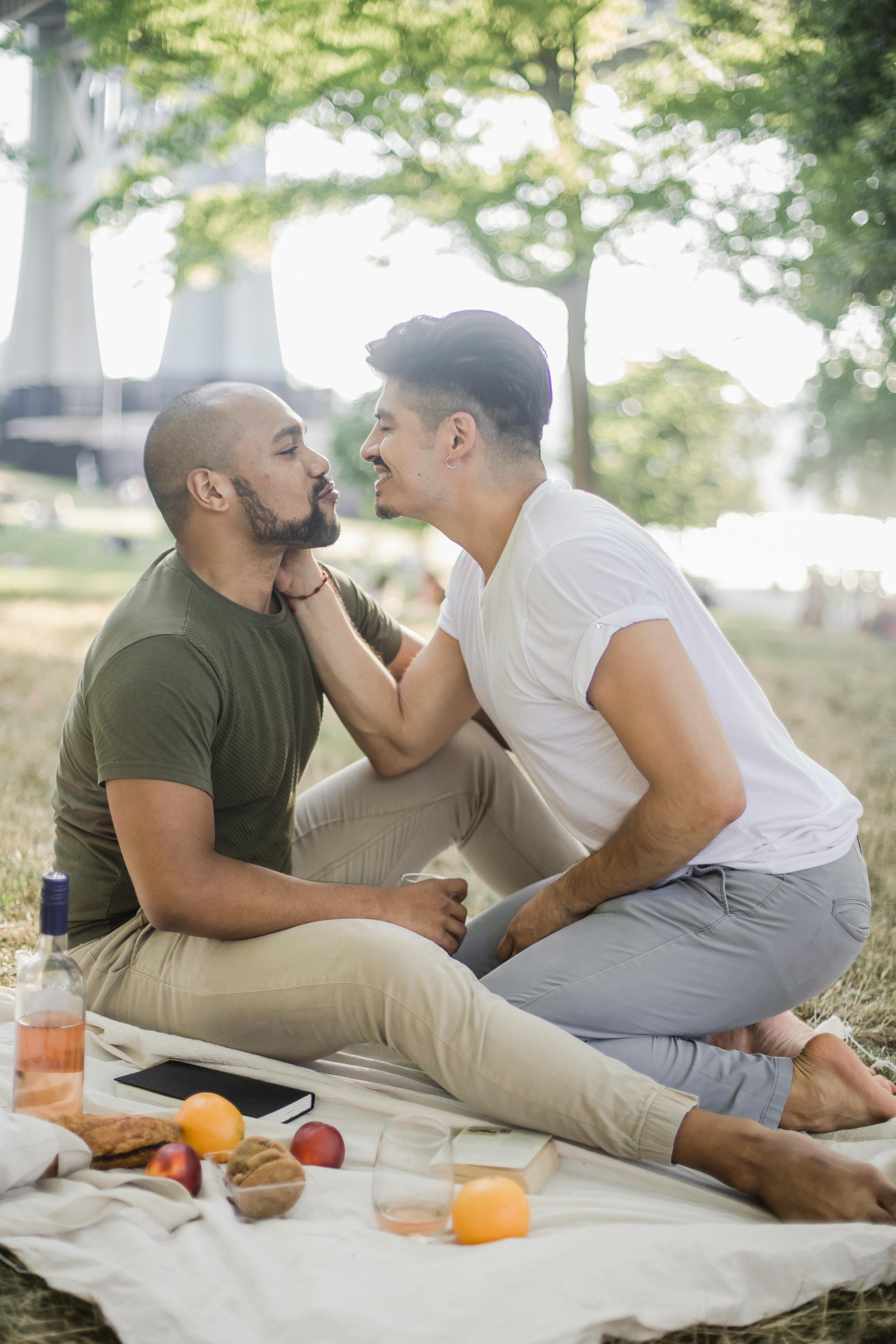 two men having a picnic and being affectionate