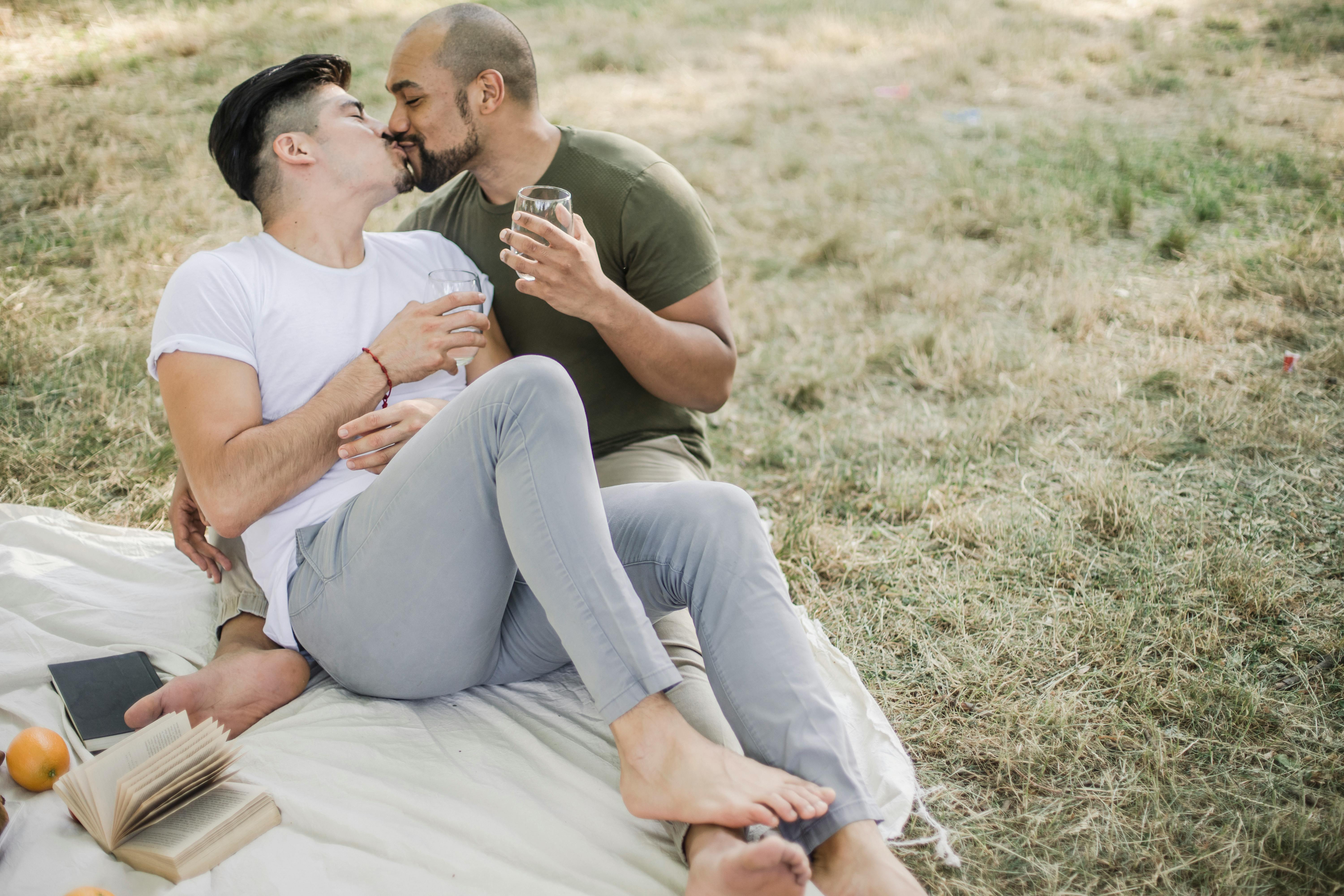 two men having a picnic and kissing
