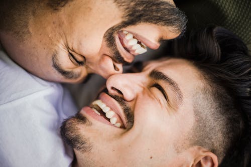 Free Close Up Photo of Happy Men Facing Each Other Stock Photo