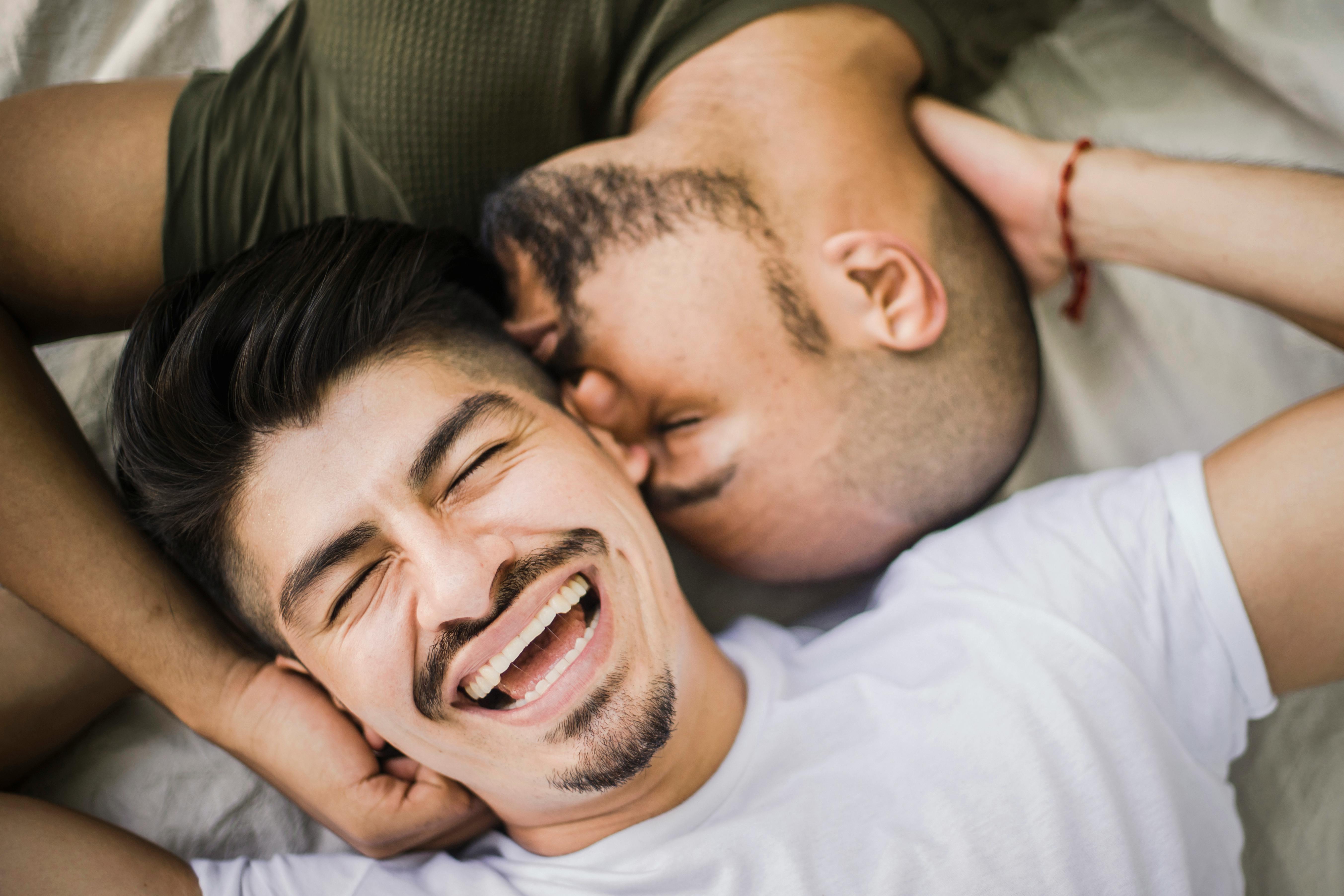 happy man being kissed by another man