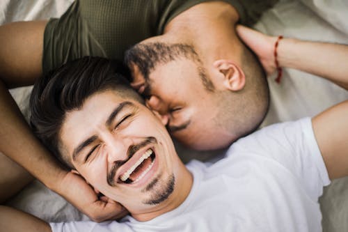 Happy Man Being Kissed by Another Man
