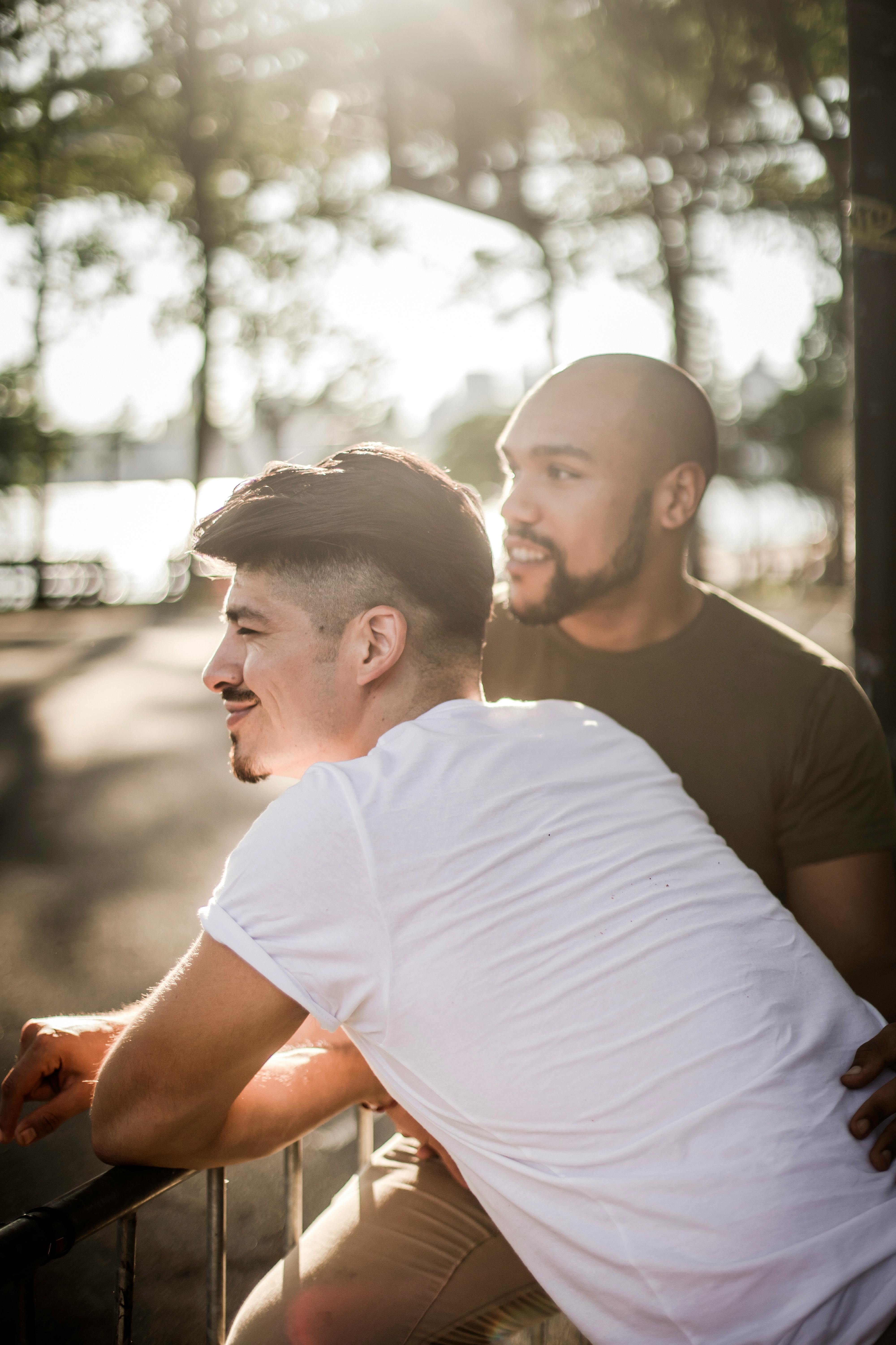 men leaning on a railing