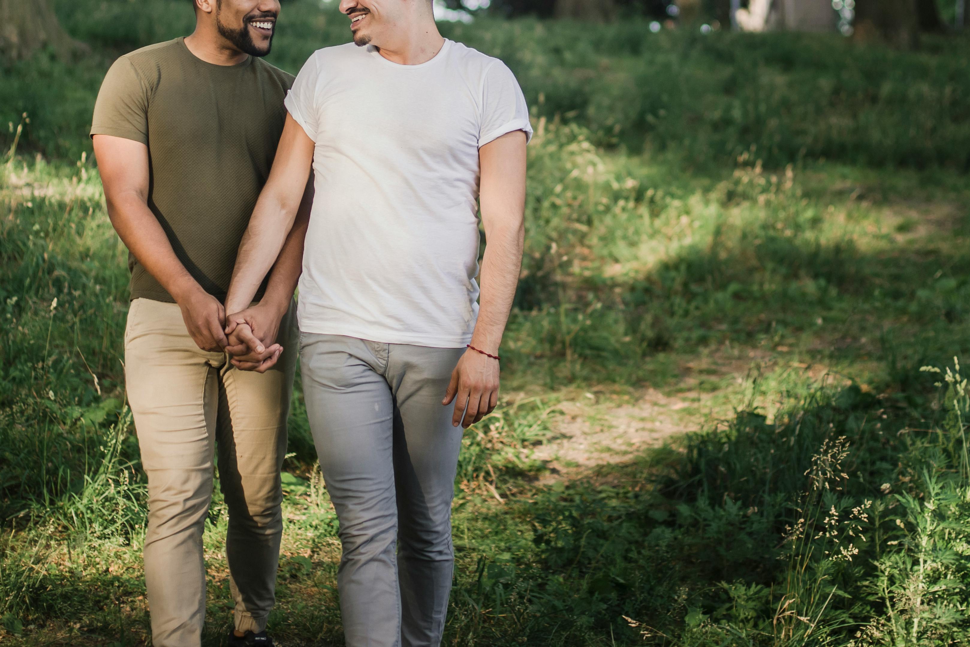 two men walking and holding hands