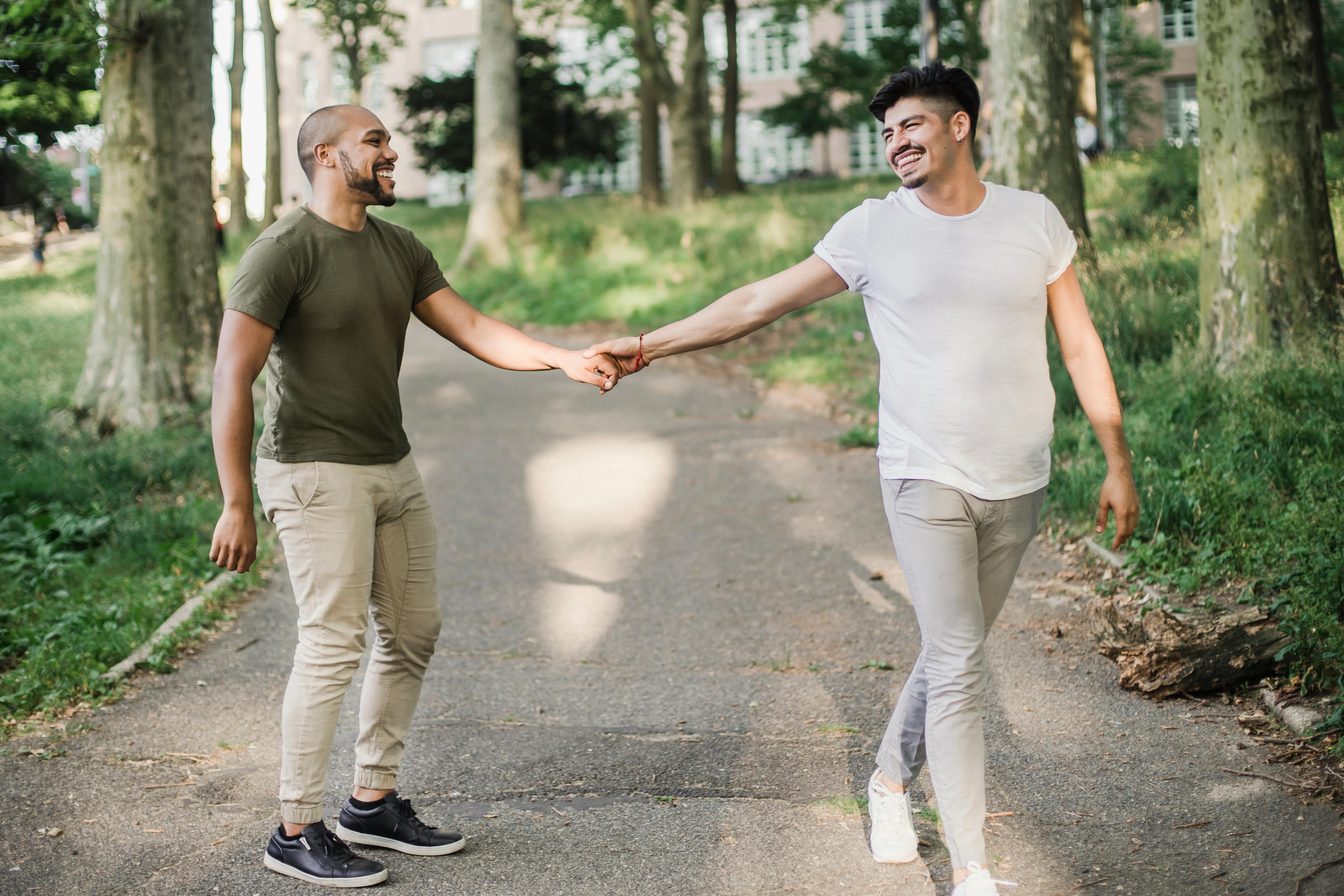 Two Men Holding Hands and Walking Together \u00b7 Free Stock Photo