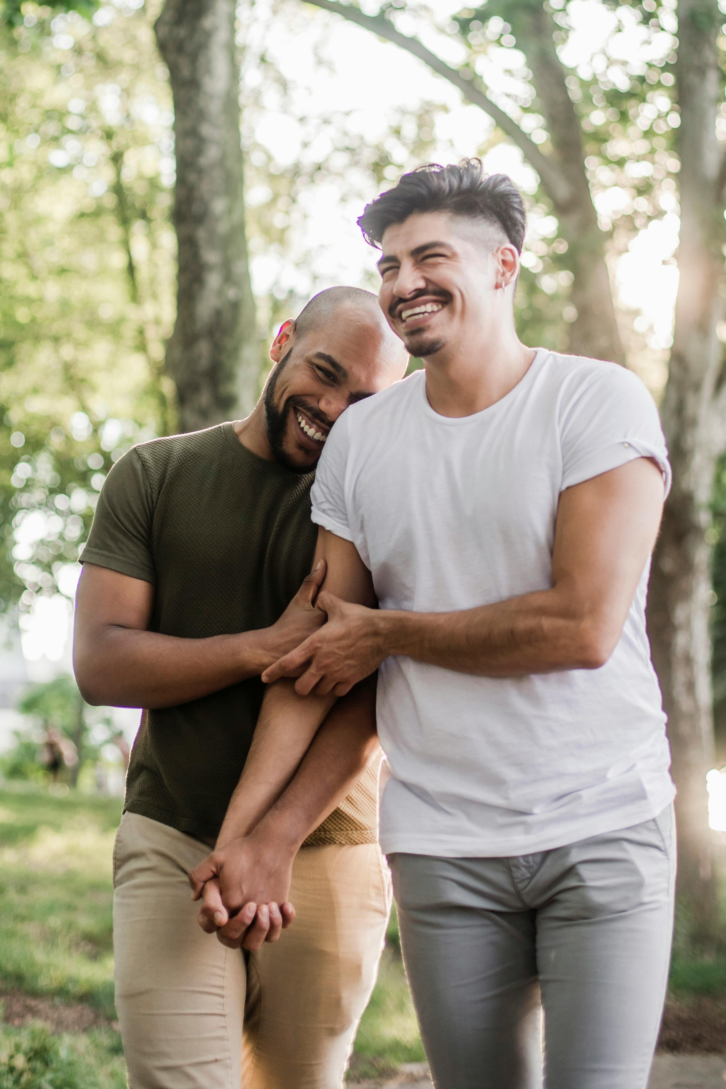 two happy men walking and holding hands