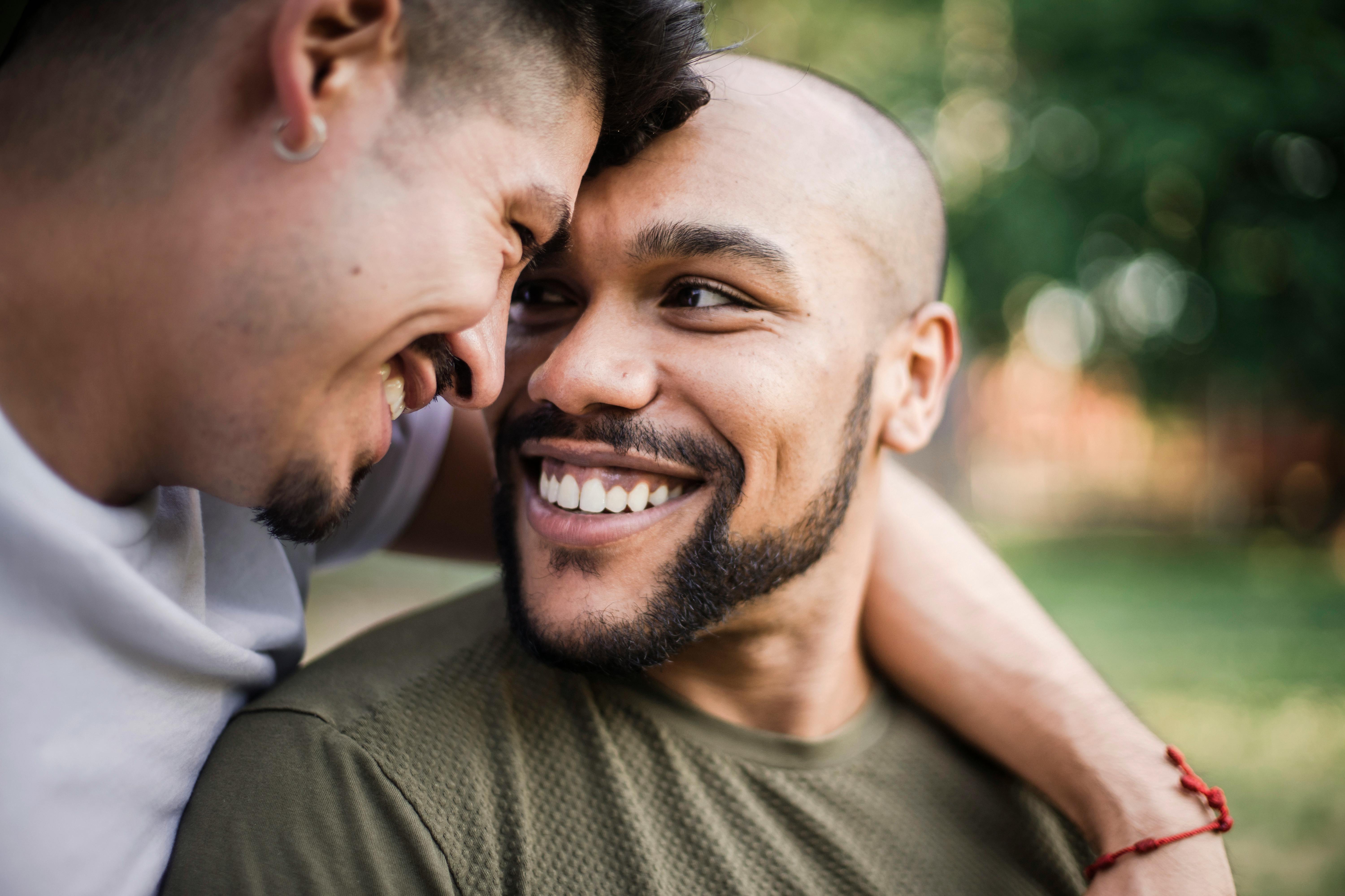 two happy men being affectionate