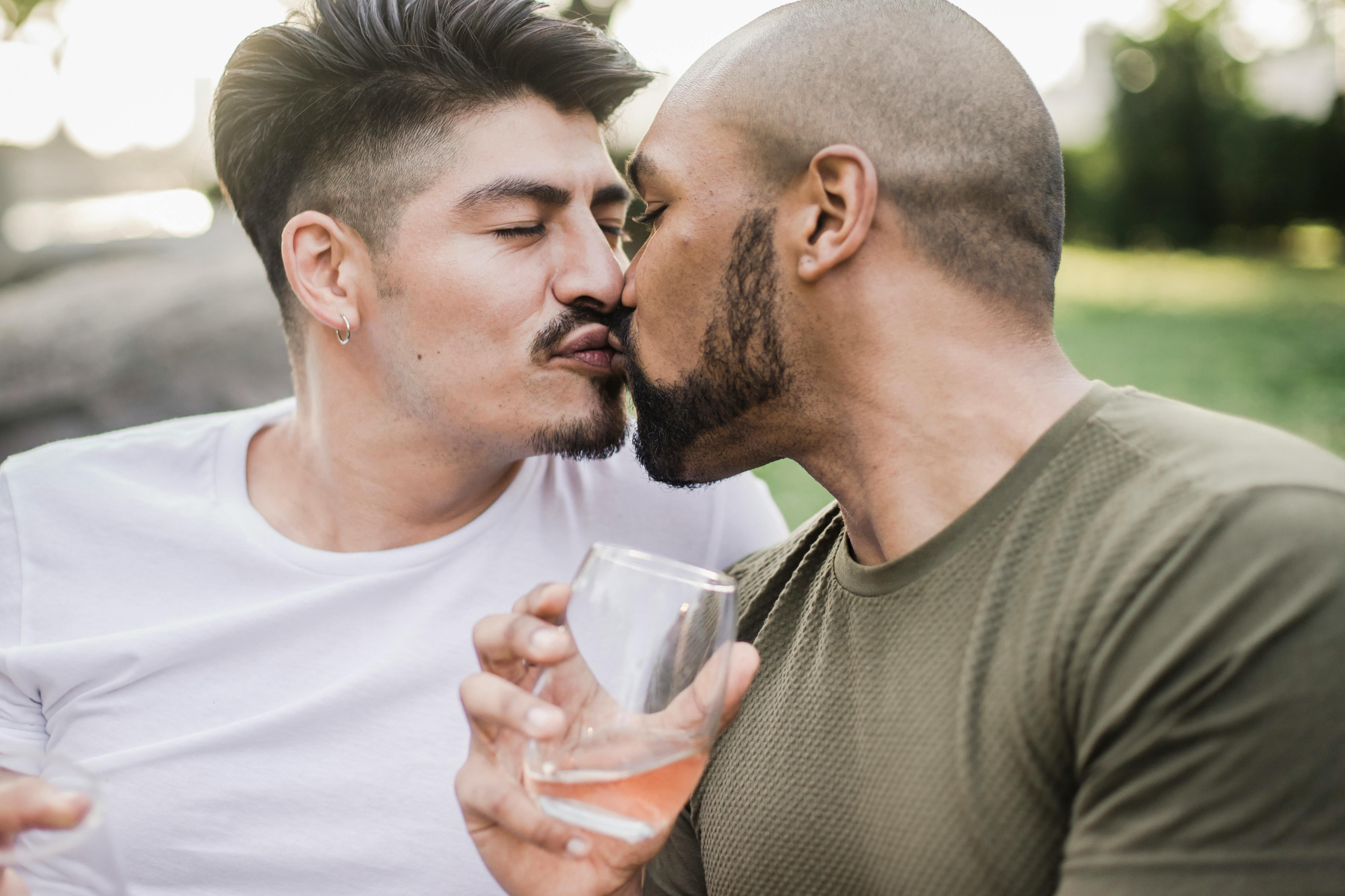 two men kissing outside