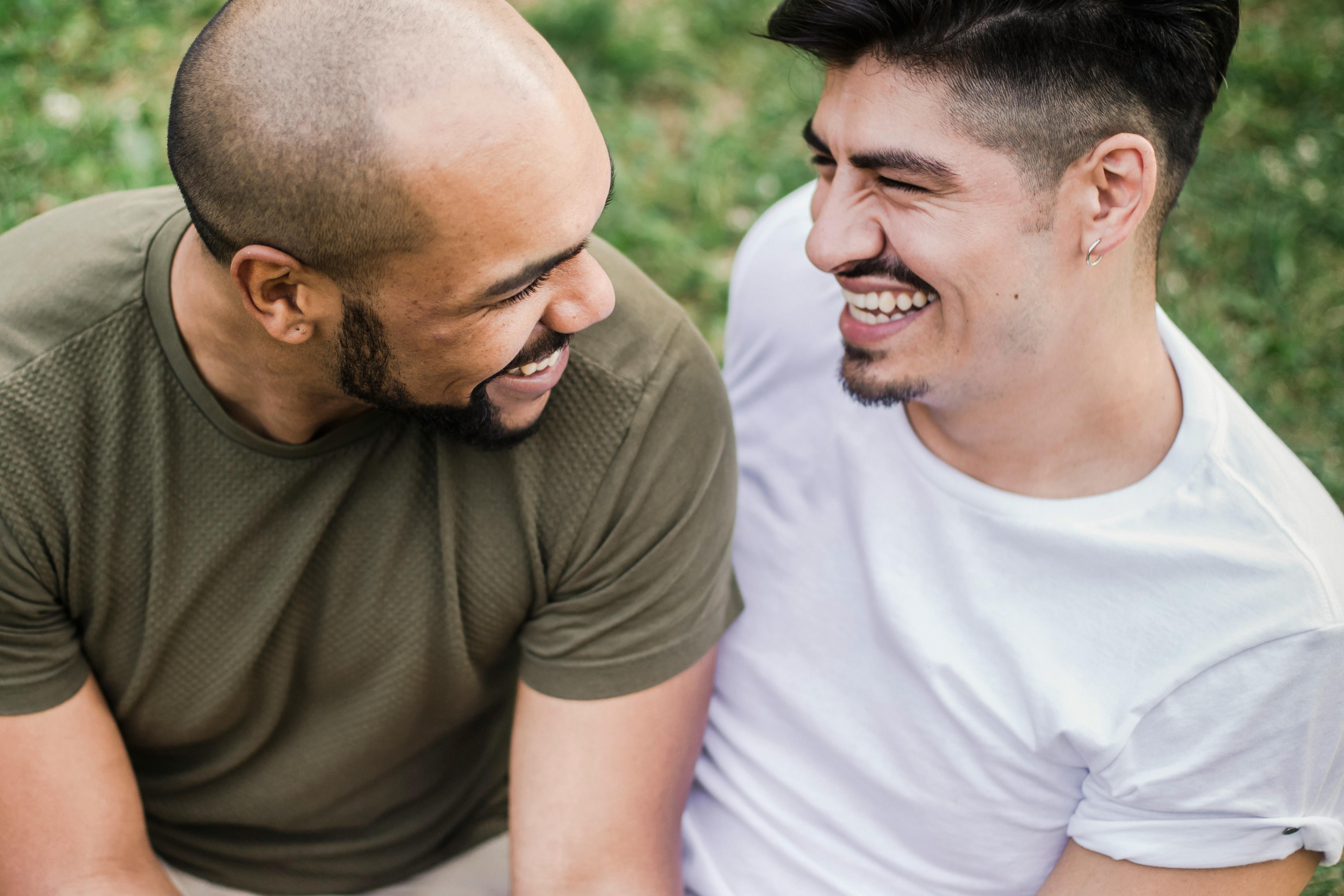 two happy men looking at each other