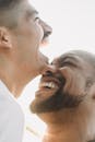 Men Touching with Faces and Smiling