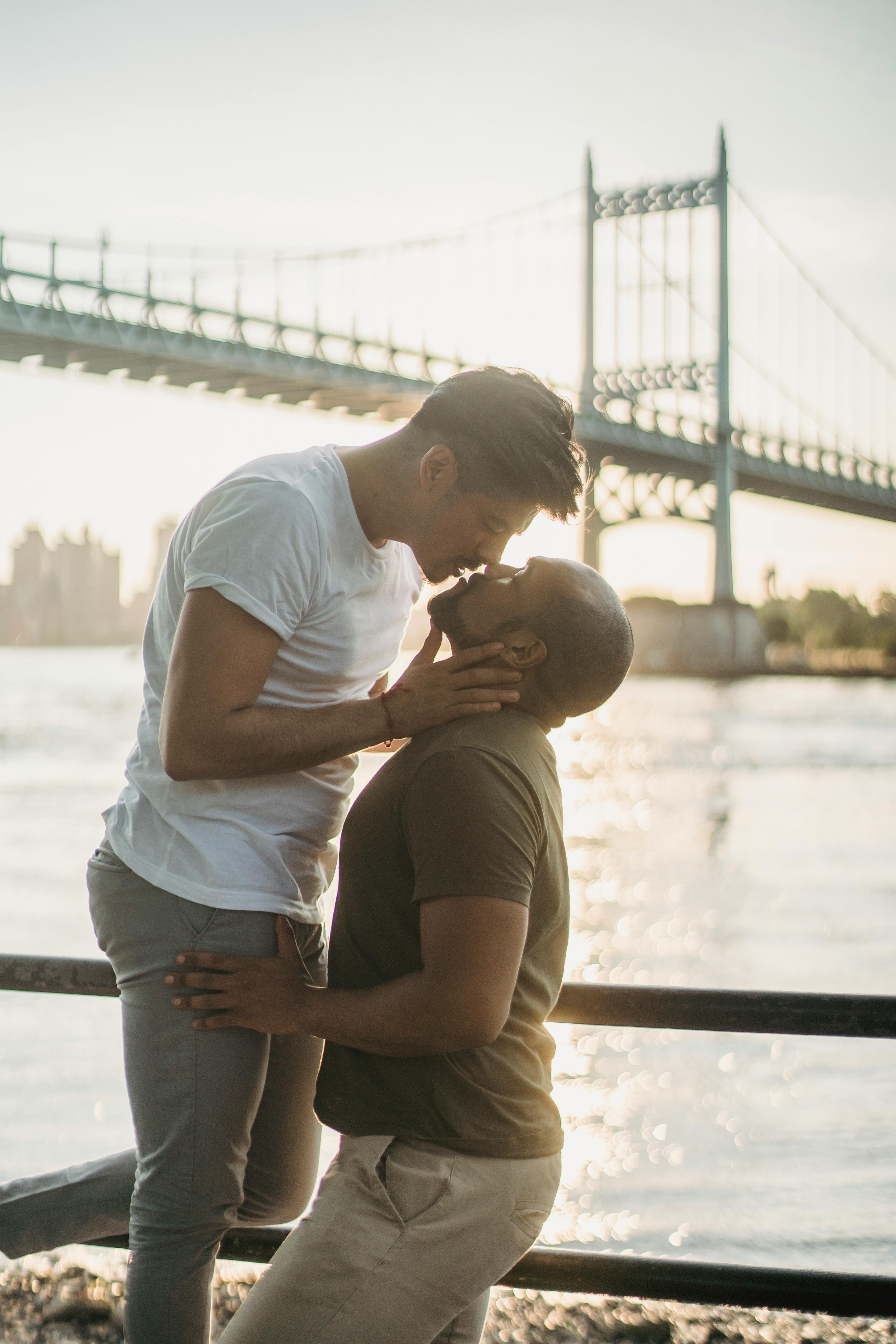 two men kissing outside