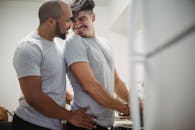 Joyful gay couple enjoying a moment together while cooking at home.