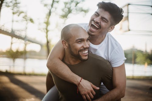 Free Man Carrying Another Man Stock Photo