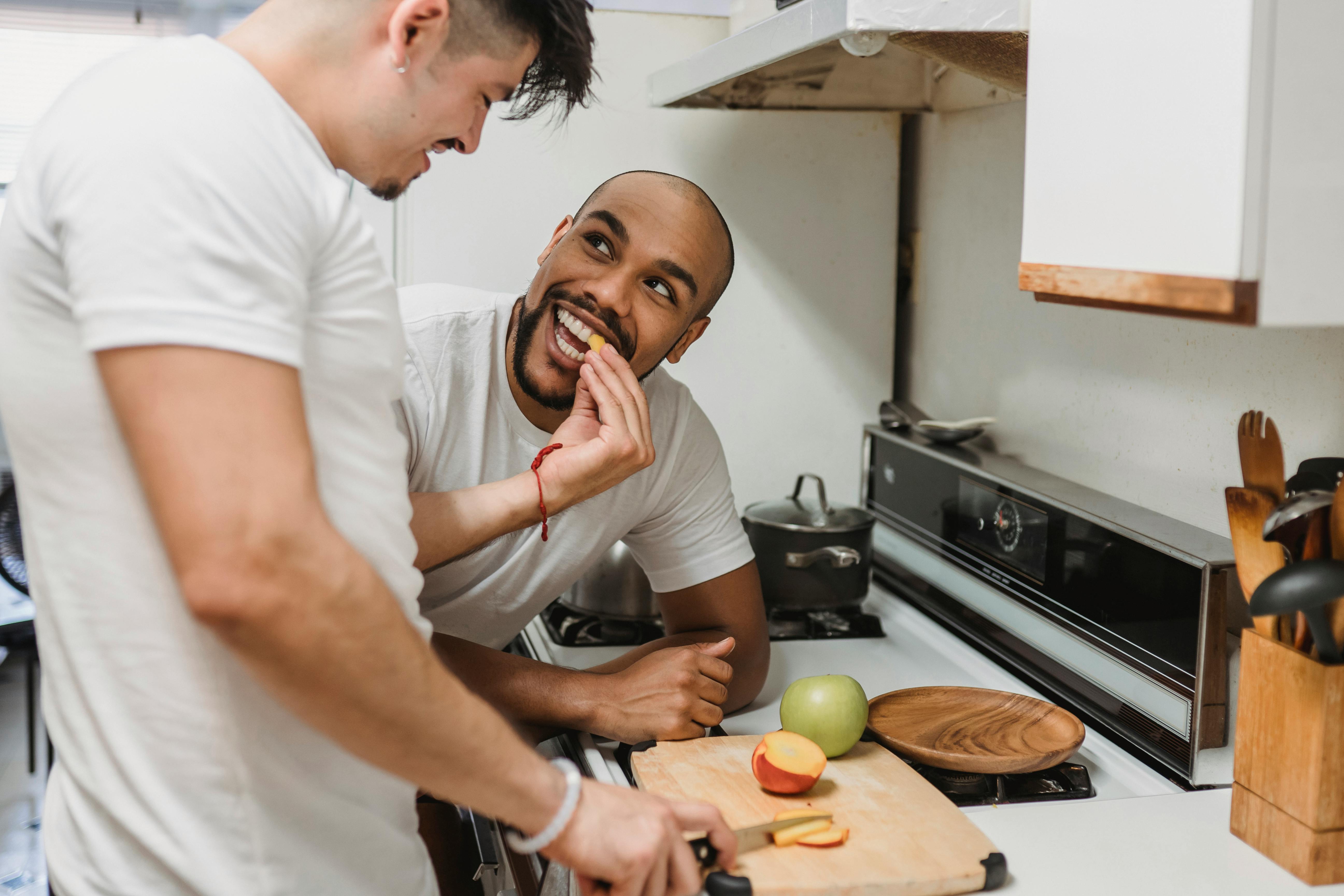 happy couple cutting fruits in the kitchen