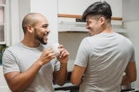 Man in Gray Crew Neck T-shirt Drinking from White Ceramic Mug