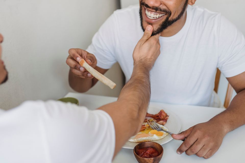 A couple sharing breakfast and talking at home