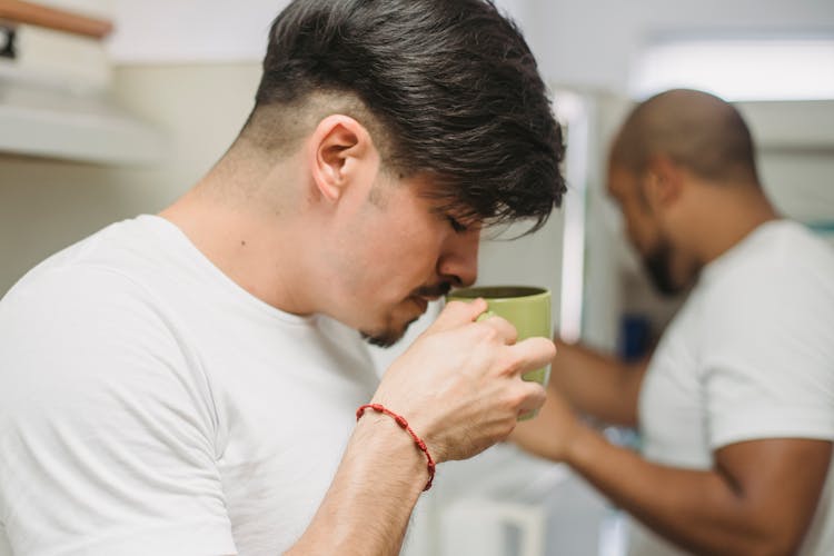 Man Drinking Coffee From A Mug