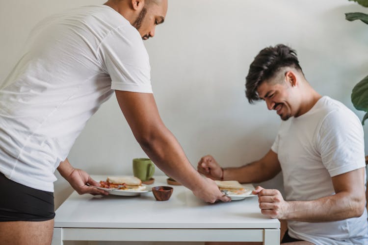 Men Serving And Eating Breakfast