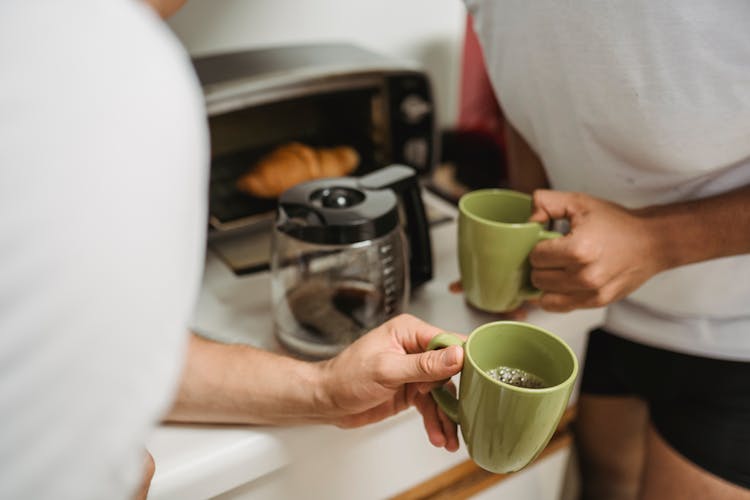 Men Holding Mugs In Hands