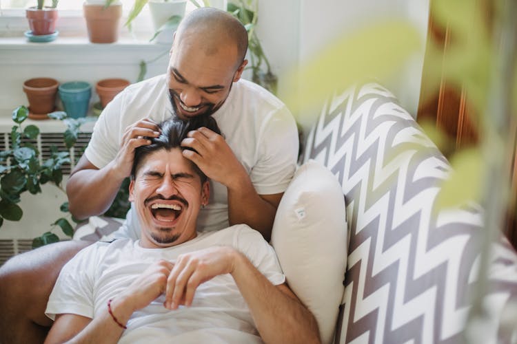 Men Laughing On A Couch