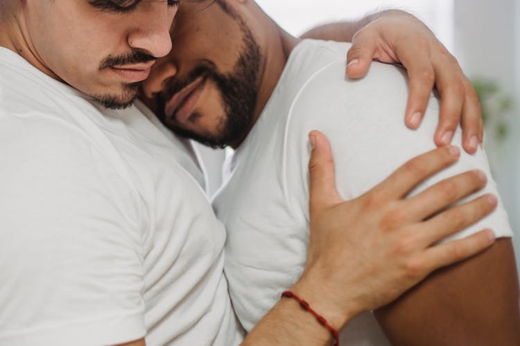 Young Man Hugging Other Man Tenderly