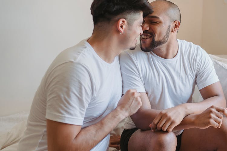 Couple Sitting In Bed About About To Kiss