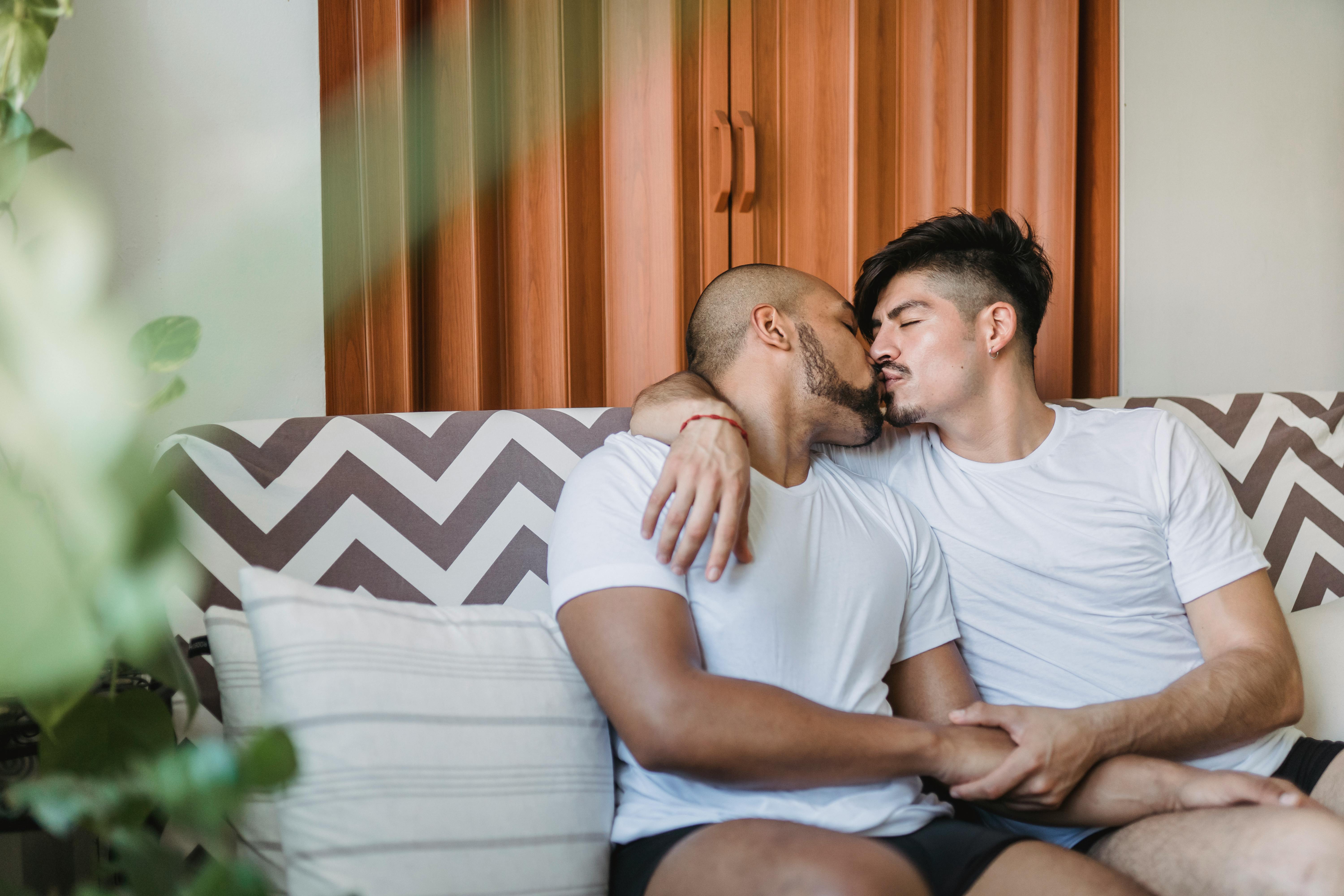 two men kissing and holding hands