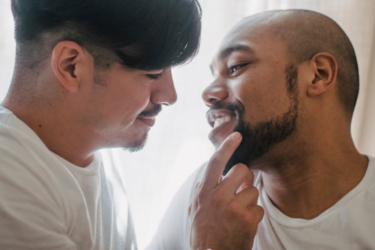 Couple About To Kiss And Looking Each Other In The Eyes And Smiling 