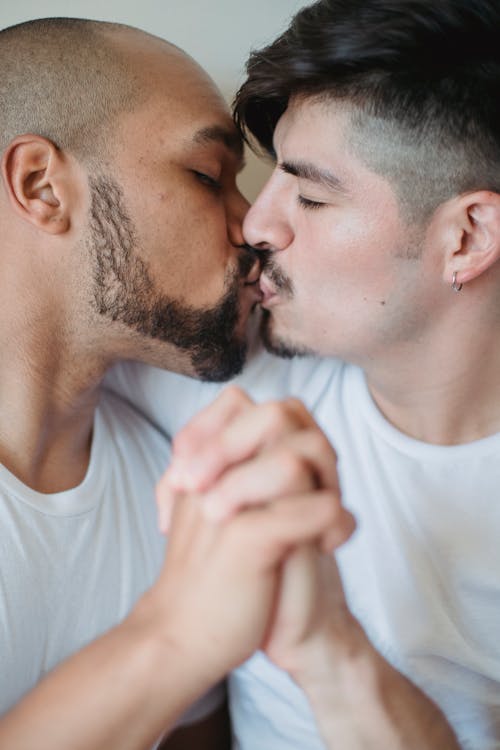 Free Two Men Kissing and Holding Hands Stock Photo