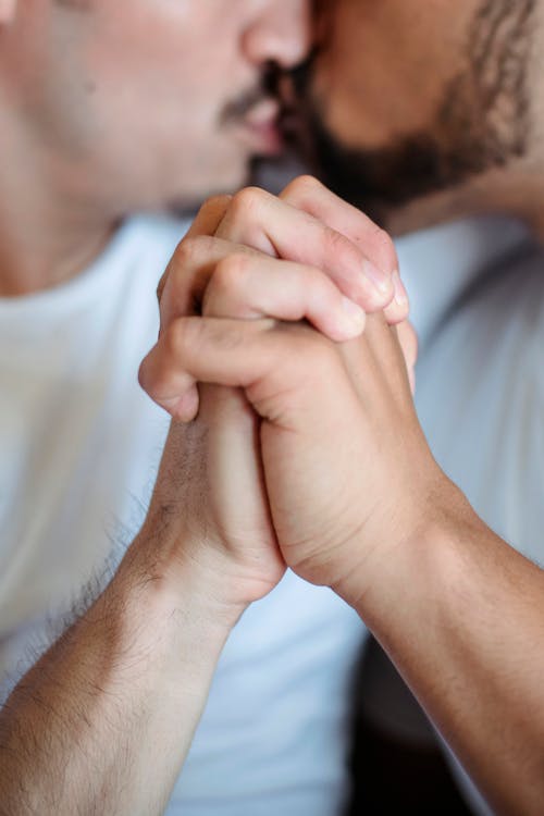 Two Men Kissing and Holding Hands