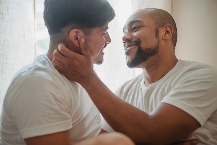 Two Men Looking Into Each Others Eyes With Affection