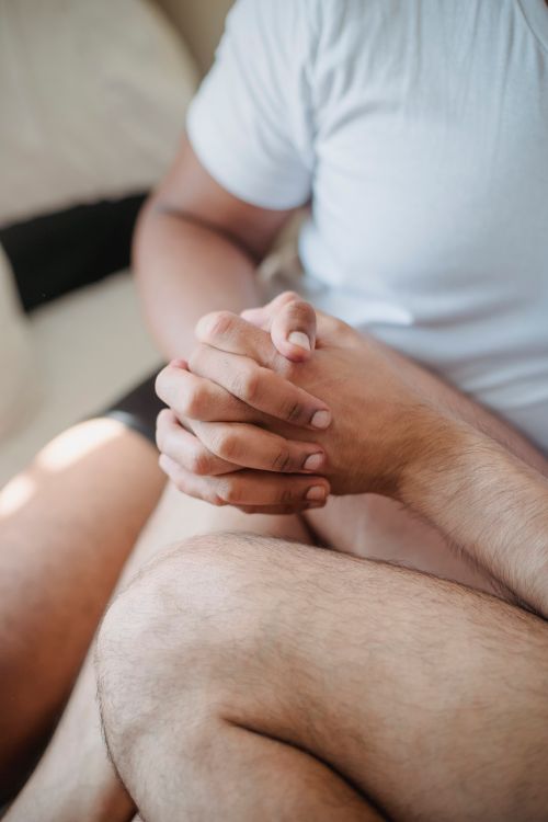 Free A close-up view of a harmonious couple holding hands, symbolizing love and unity. Stock Photo
