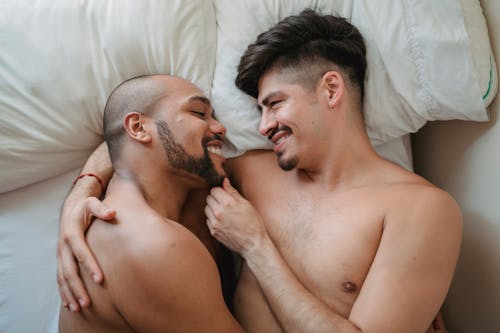 Couple Lying in Bed and Hugging 