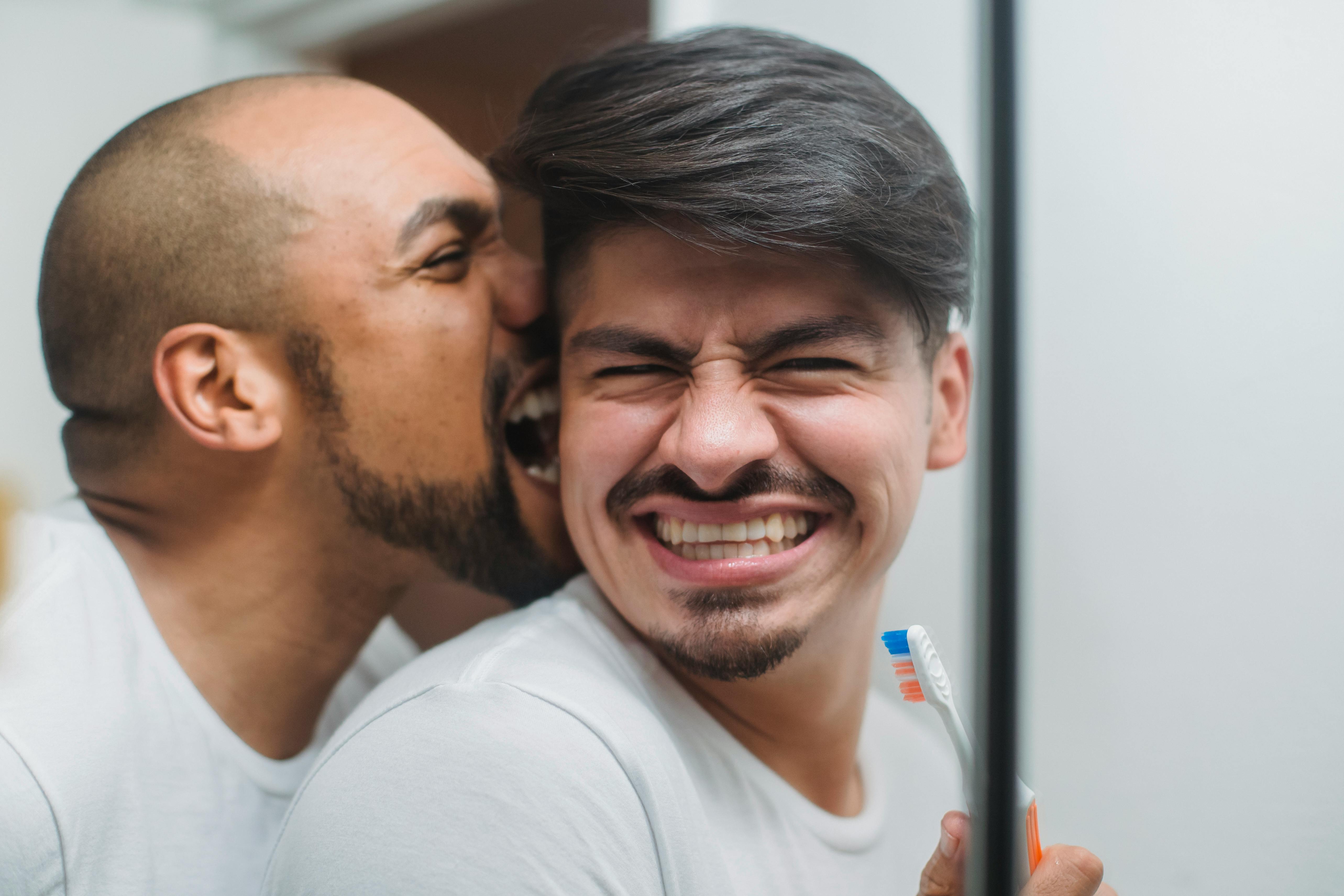 man biting another man playfully