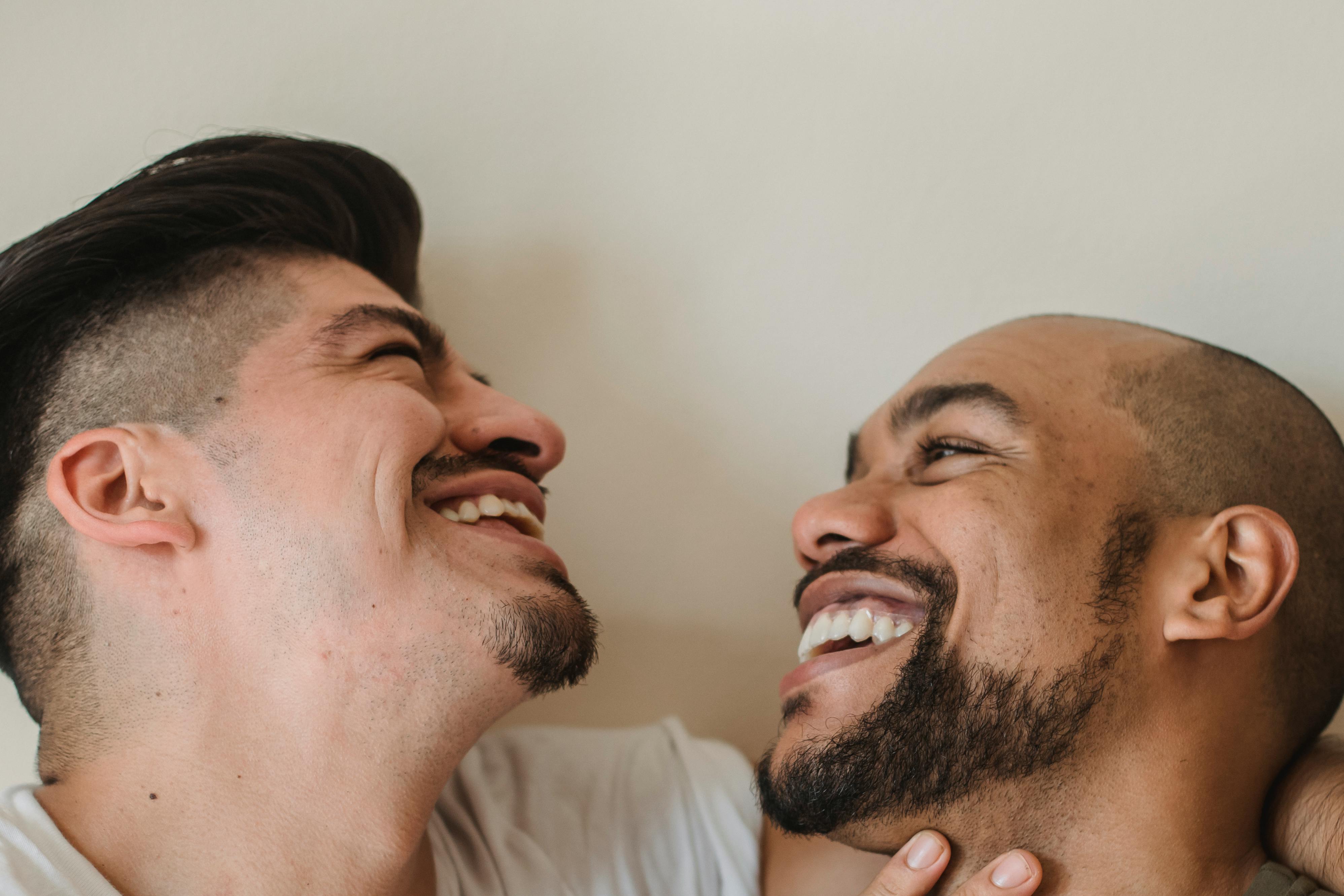 Portrait of Two Men Smiling at Each Other · Free Stock Photo