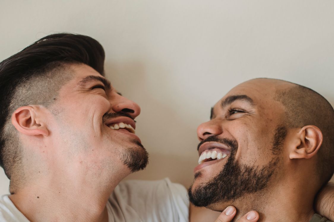 Portrait of Two Men Smiling at Each Other · Free Stock Photo