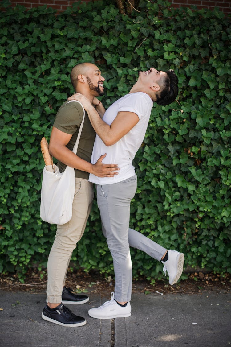 Men Hugging By Growing Vines