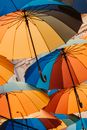 Colorful composition of umbrellas floating above street