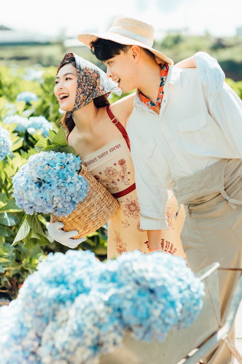 Happy Asian couple with flowers