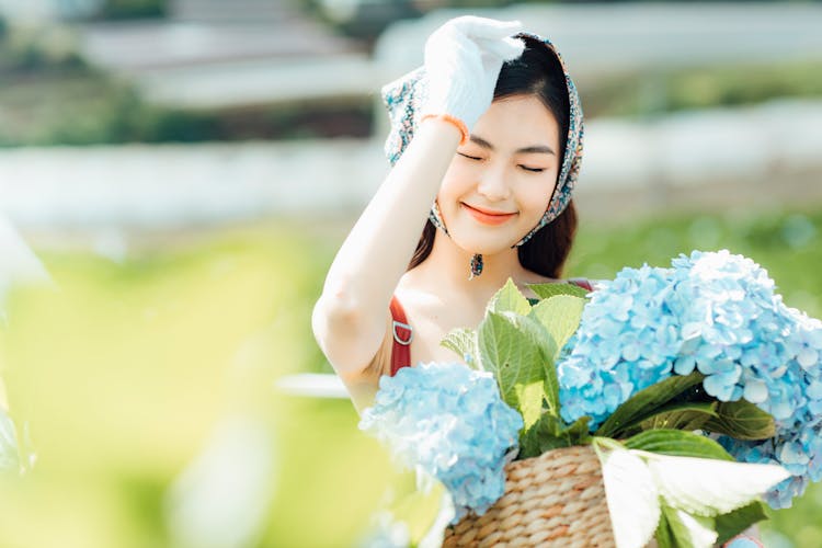 Joyful Asian Woman With Flowers