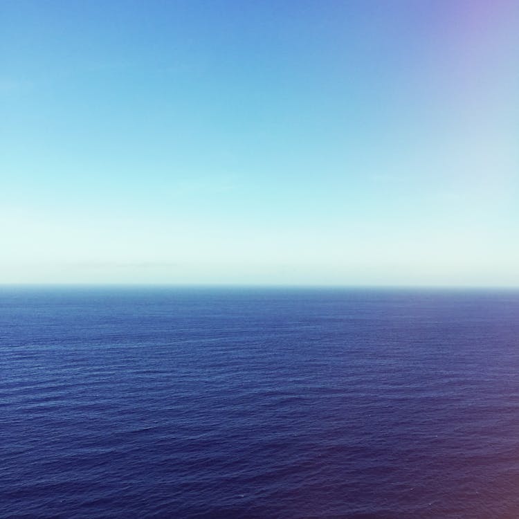 Wavy Blue Ocean Under Blue Sky · Free Stock Photo