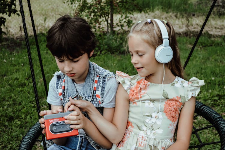 Kids Listening To Music In Park