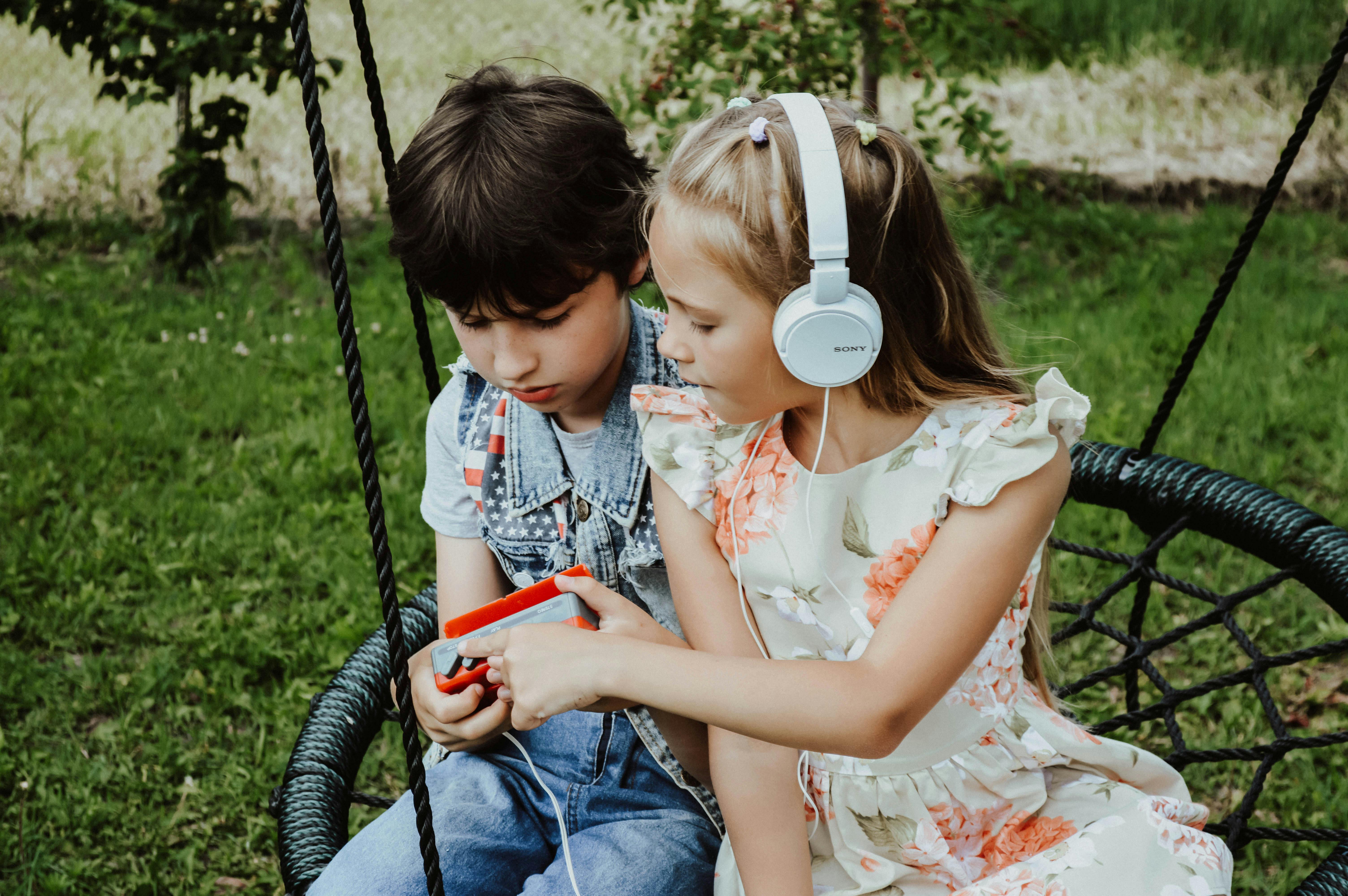 content children listening to music on playground